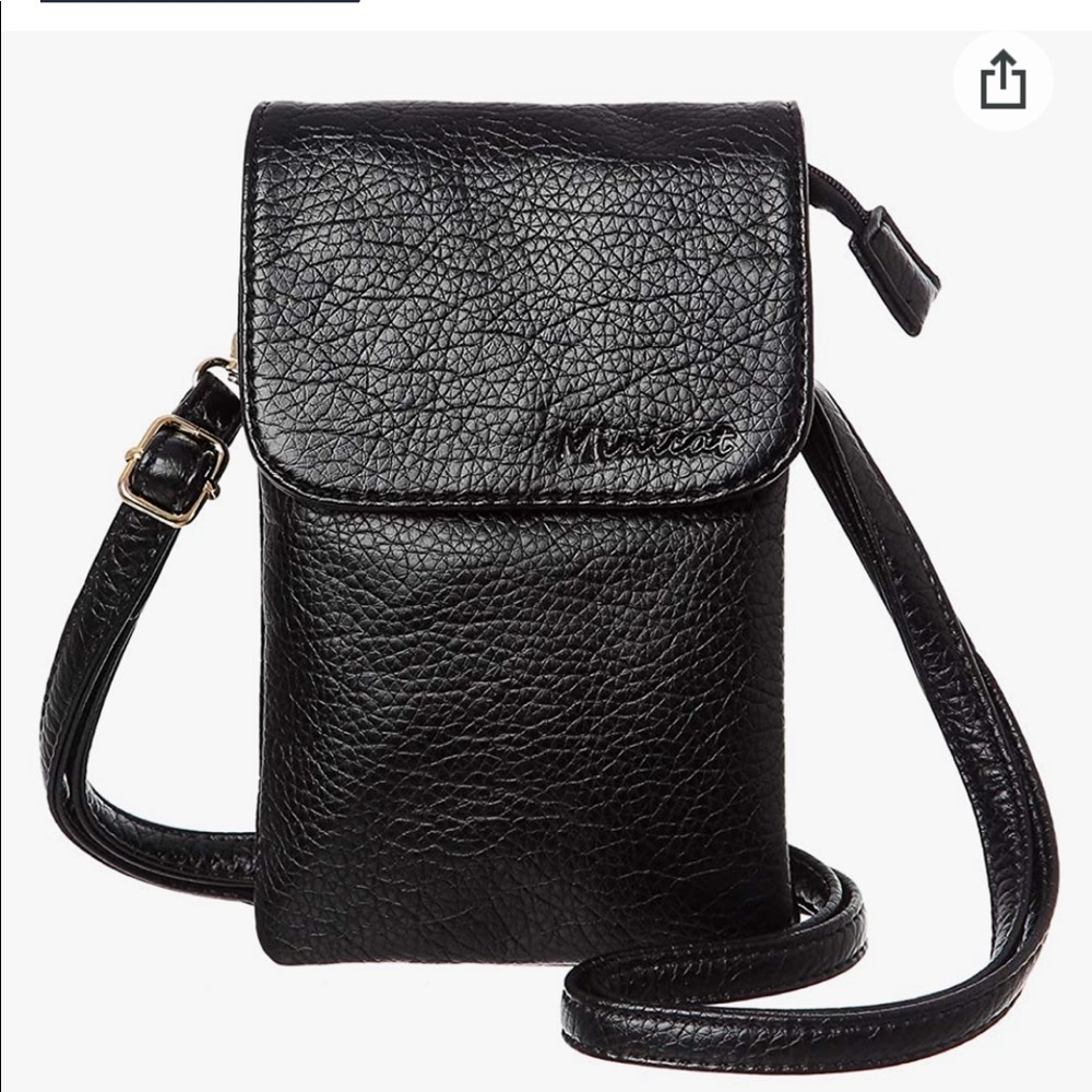 Minicat Black adjustable crossbody, purse with gold accents New without tags